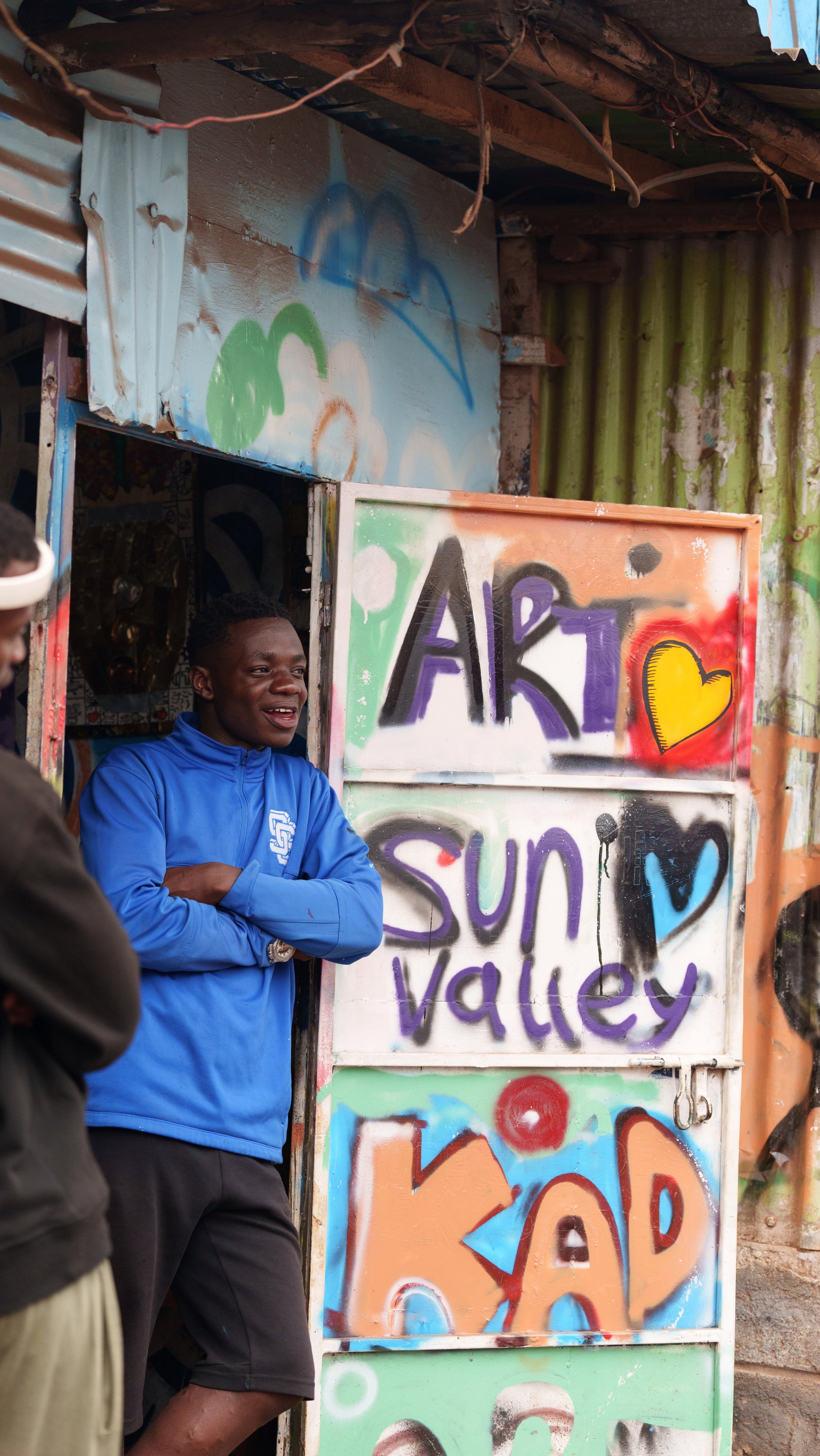 Saviour Juma (Artist) standing in front of his studio in Nairobi